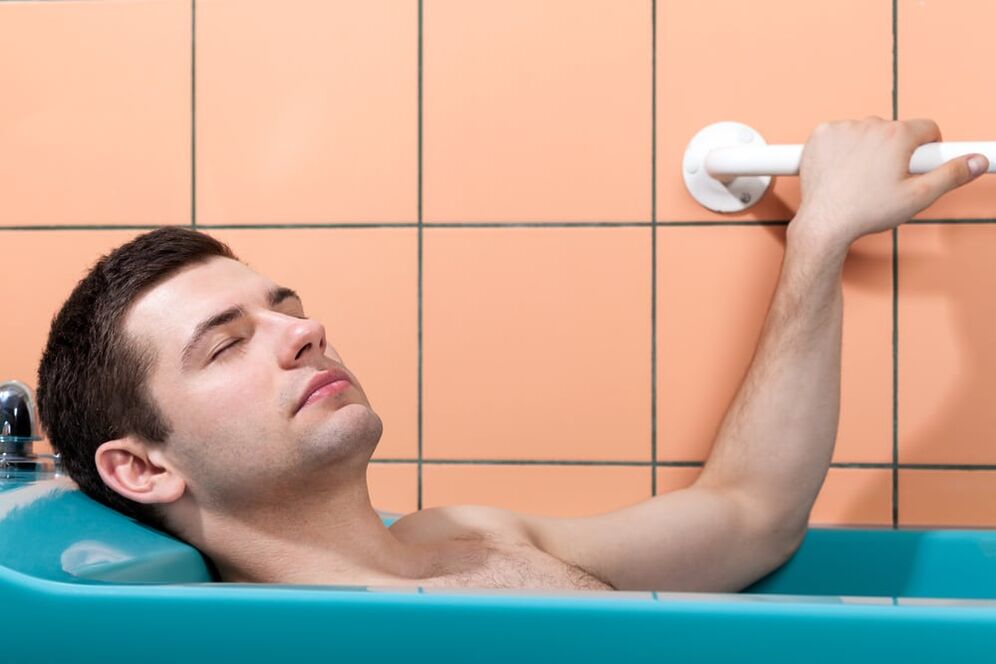 A man takes a bath with baking soda to enlarge his penis